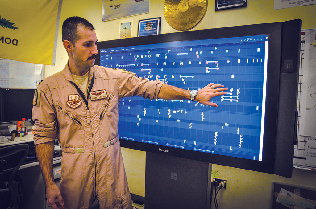 man pointing to screen with display of technology software 