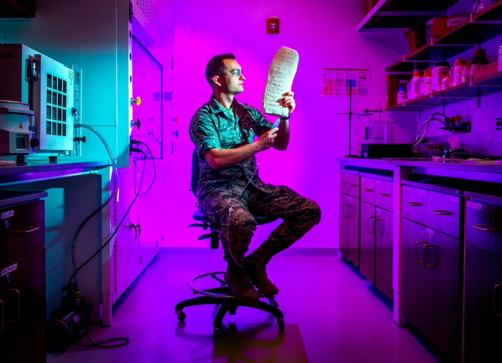 airmen looking at prototype in lab 