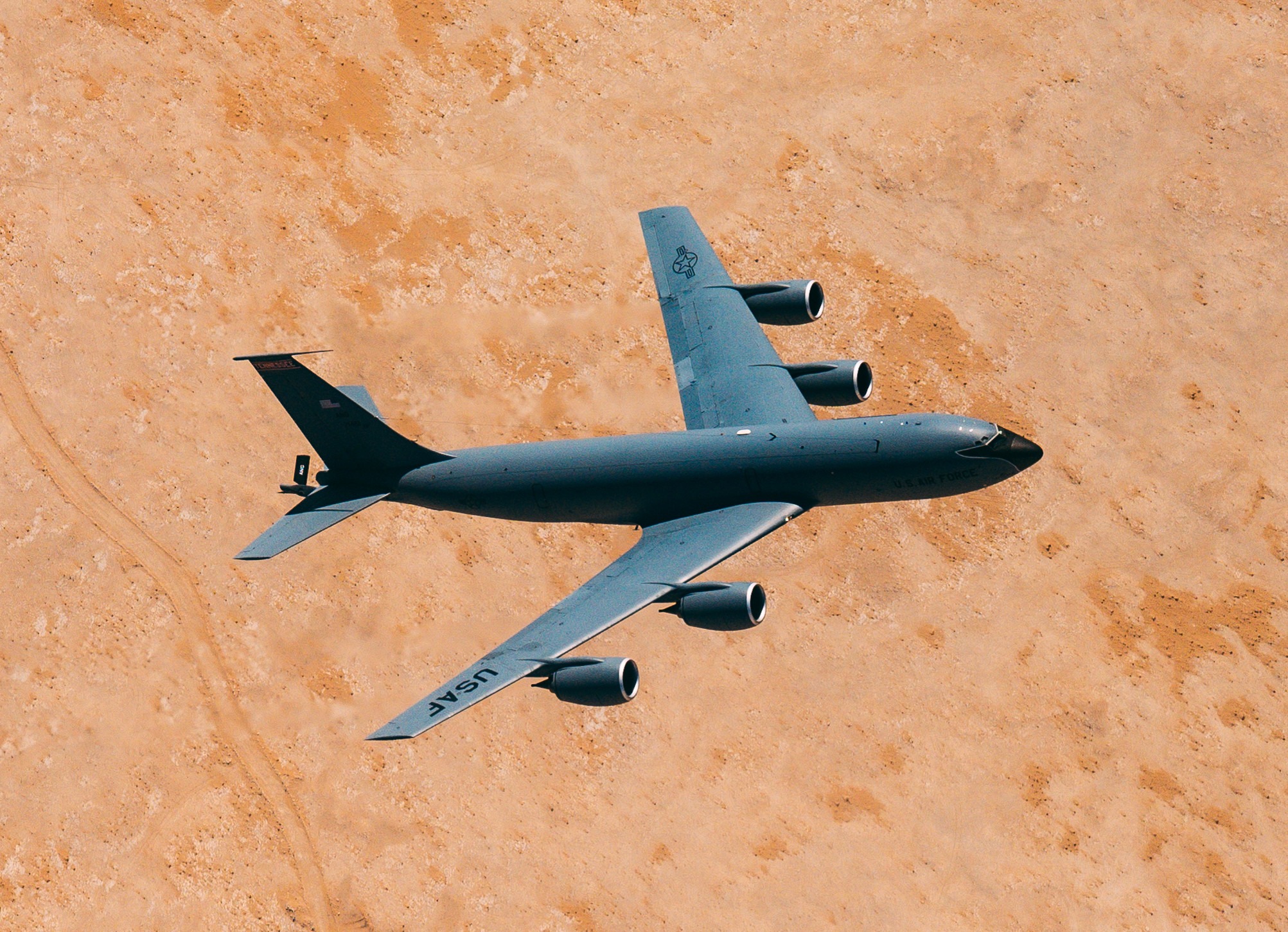aircraft flying over desert